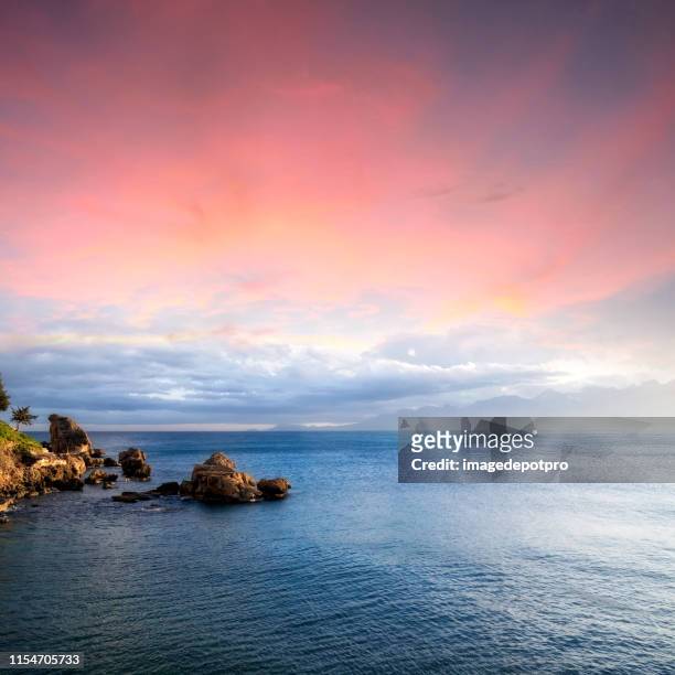 seascape with rocky shore over cloudy sunset sky - romantic sky stock pictures, royalty-free photos & images