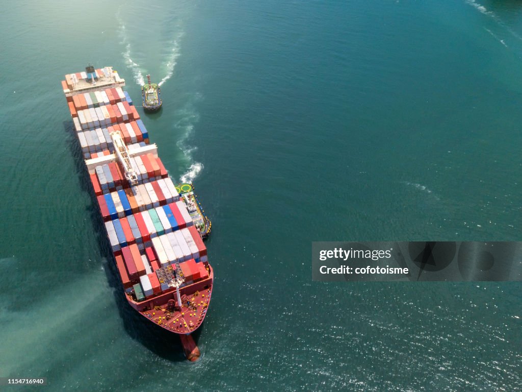 Aerial view Container cargo ship in the sea carrying to Terminal Port,Industry business logistic and transportation in Thailan