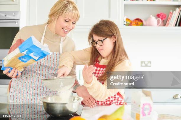 baking with mum - down syndrome cooking stock pictures, royalty-free photos & images