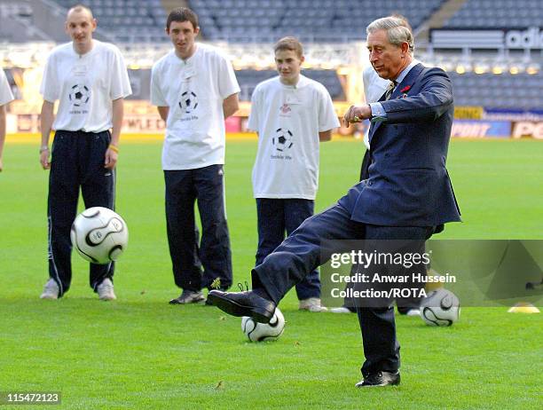 Prince of Wales kicks a penalty during a visit to Newcastle United's St James' Park ground on November 8, 2006. The Royal couple are on a two-day...