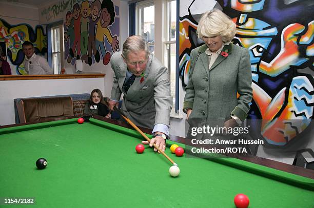 Prince Charles, Prince of Wales watched by Camilla, Duchess of Cornwall, plays Snooker with teenagers when they visit the Jubilee Institute at...