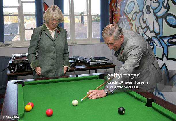 Prince Charles, Prince of Wales watched by Camilla, Duchess of Cornwall, plays Snooker with teenagers when they visit the Jubilee Institute at...