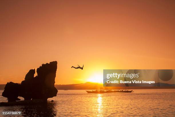 Man diving at sunset