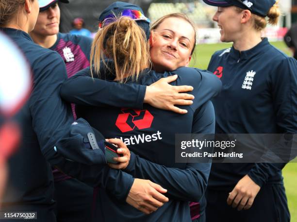 Laura Marsh of England is congratulated by team mates after being presented with her 100th Cap during the 2nd Royal London Women's ODI match between...