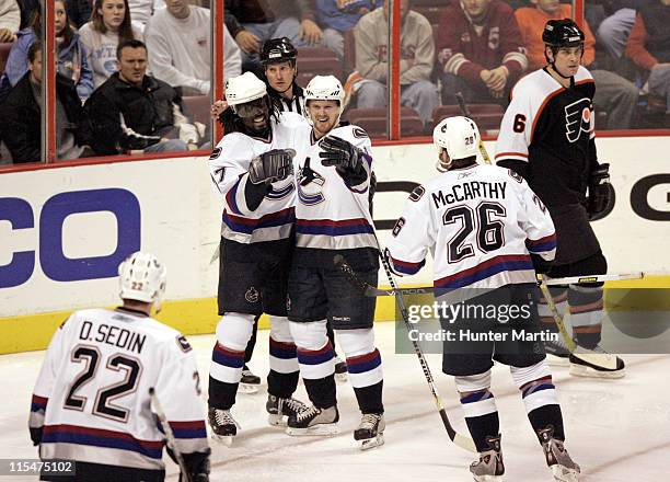 Canucks right winger Anson Carter celebrates with team mates after scoring his second goal of the game at The Wachovia Center. Vancouver Canucks vs...