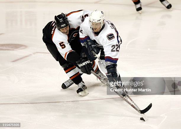 Flyer defenseman Kim Johnsson stick checks Canucks left winger Daniel Sedin at The Wachovia Center. Vancouver Canucks vs Philadelphia Flyers,...