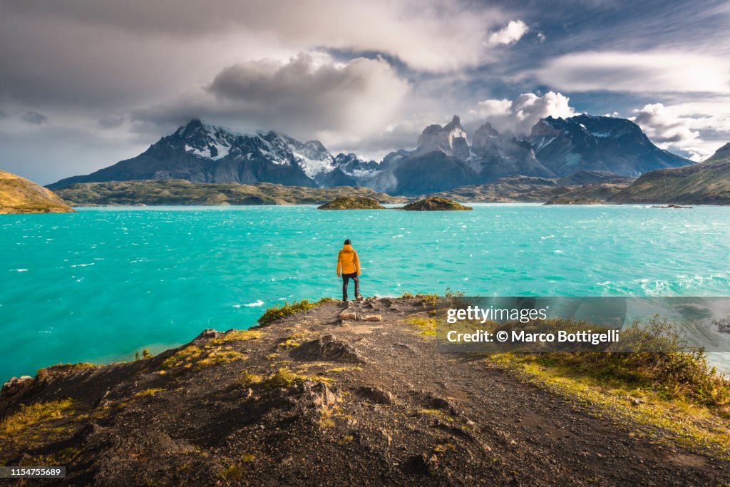 Tourist admiring the Cordillera Paine in Torres del Paine National Park, Chile