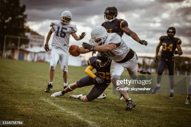 scoring touchdown! - first down american football stock pictures, royalty-free photos & images
