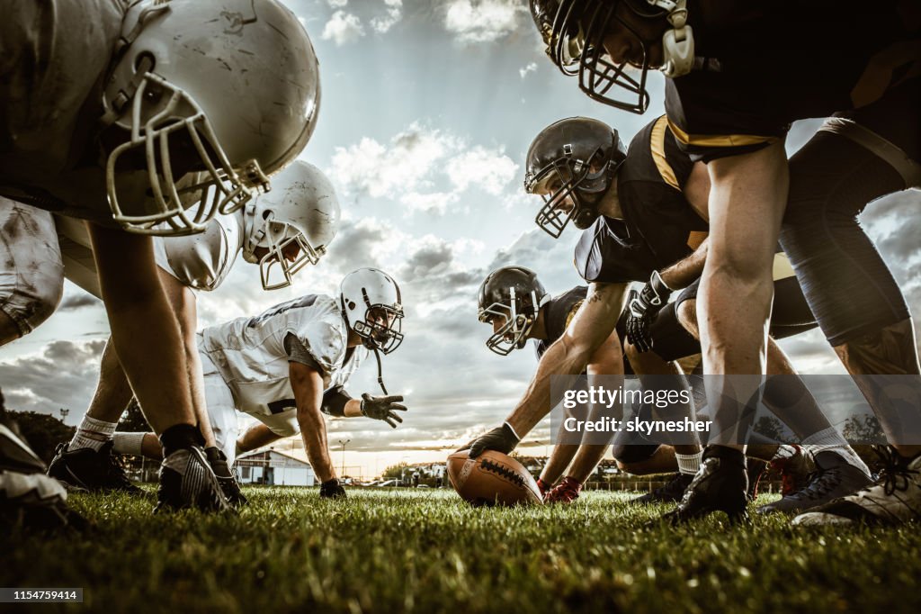 Below view of American football players on a beginning of the match.