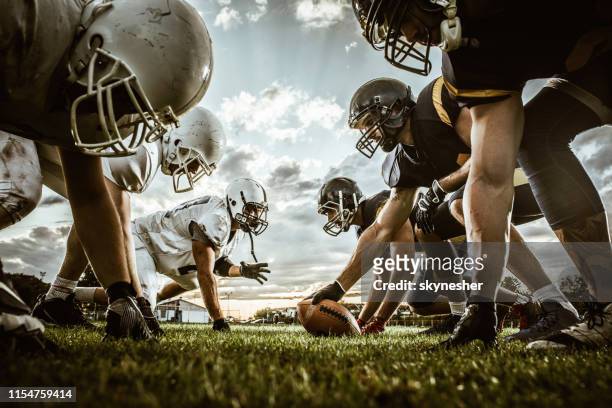 below view of american football players on a beginning of the match. - american football stock pictures, royalty-free photos & images