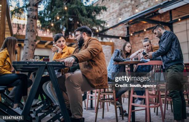 friends talking on a coffee break - coffee on patio stock pictures, royalty-free photos & images