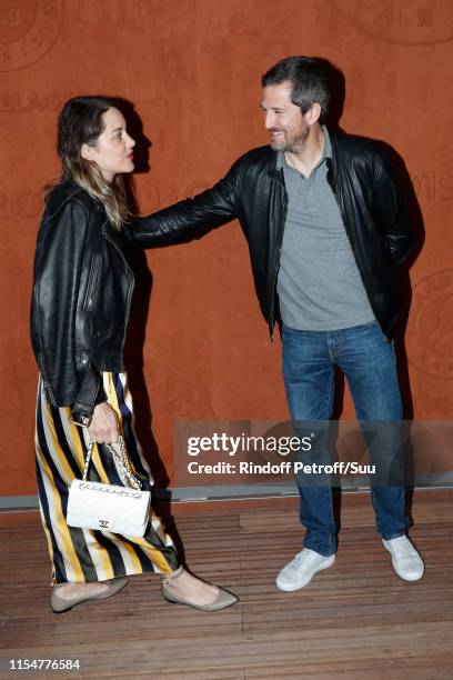 Actors Marion Cotillard and Guillaume Canet attend the 2019 French Tennis Open - Day Fifteen at Roland Garros on June 09, 2019 in Paris, France.