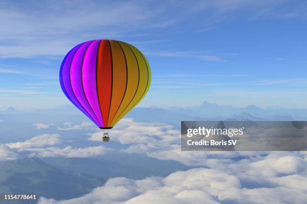 hot air balloon over the mountain range - rainbow clouds stock pictures, royalty-free photos & images