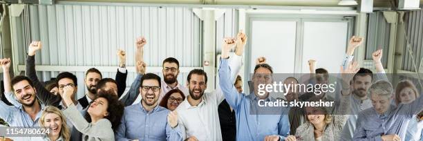 panoramic view of crowd of cheerful business people celebrating their success in the office. - crowd excitement stock pictures, royalty-free photos & images