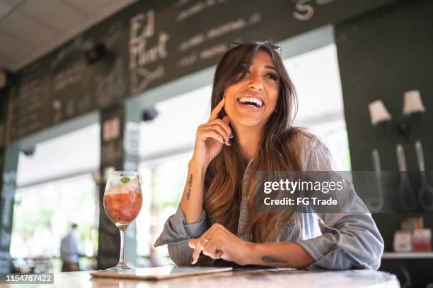 happy woman using digital tablet at restaurant - cachaça stock pictures, royalty-free photos & images