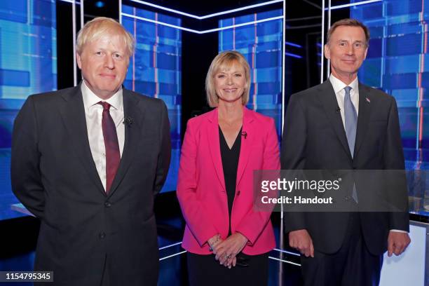 In this handout image provided by ITV, Boris Johnson, Host Julie Etchingham and Jeremy Hunt pose ahead of the Jeremy Hunt and Boris Johnson debate...