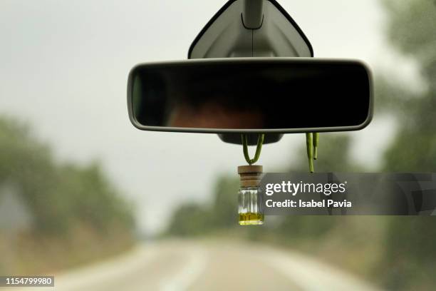 air freshener hanging on a rearview mirror - specchietto di veicolo foto e immagini stock