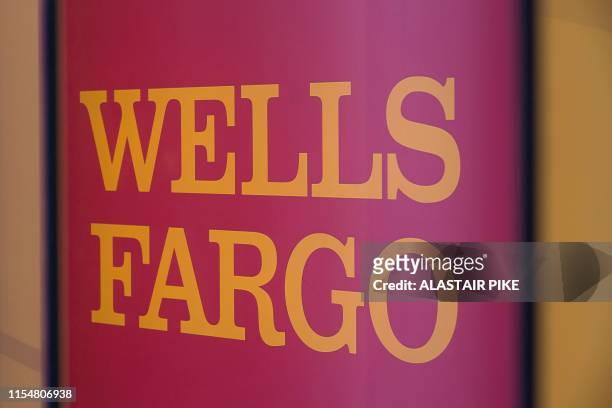 The Wells Fargo logo is seen inside a branch in Washington, DC, on July 9, 2019. - A trio of US banks reported strong profits on July 14 boosted by...
