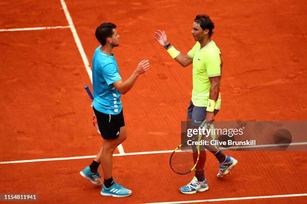 Rafael Nadal of Spain embraces Dominic Thiem of Austria following victory in the mens singles final during Day fifteen of the 2019 French Open at...