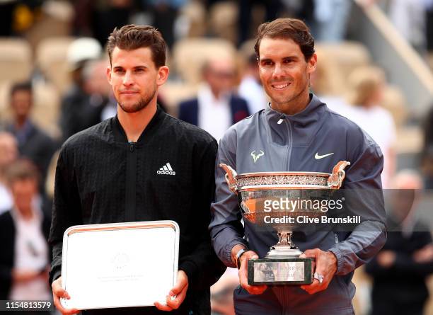 Winner, Rafael Nadal of Spain stands next to runner up Dominic Thiem of Austria with their trophies following their mens singles final during Day...