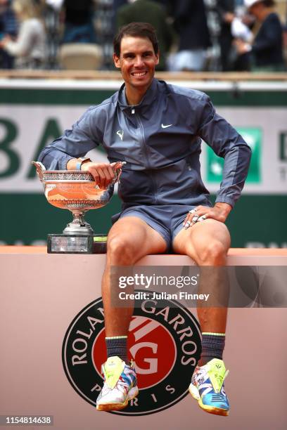 Rafael Nadal of Spain celebrates with the trophy following the mens singles final against Dominic Thiem of Austria during Day fifteen of the 2019...