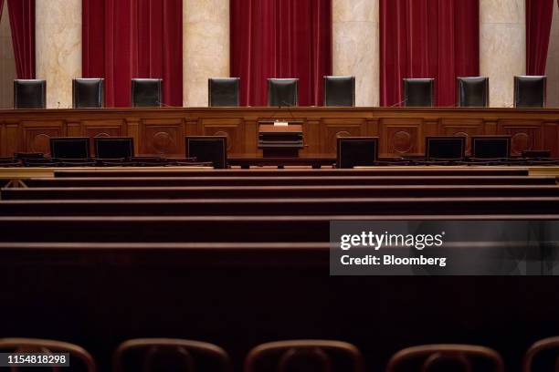 Chairs of U.S. Supreme Court justices sit behind the courtroom bench in Washington, D.C., U.S., on Tuesday, July 9, 2019. At the end of its term, the...