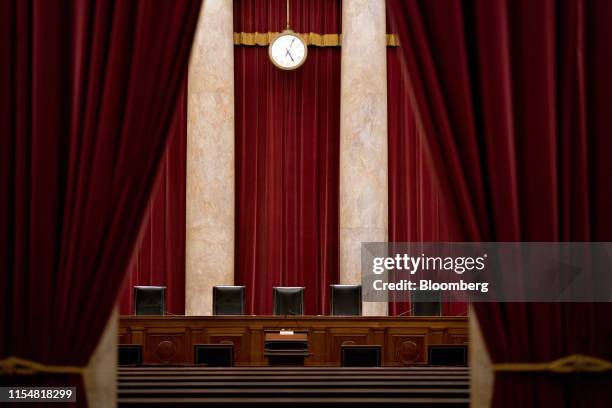 Chairs of U.S. Supreme Court justices sit behind the courtroom bench in Washington, D.C., U.S., on Tuesday, July 9, 2019. At the end of its term, the...