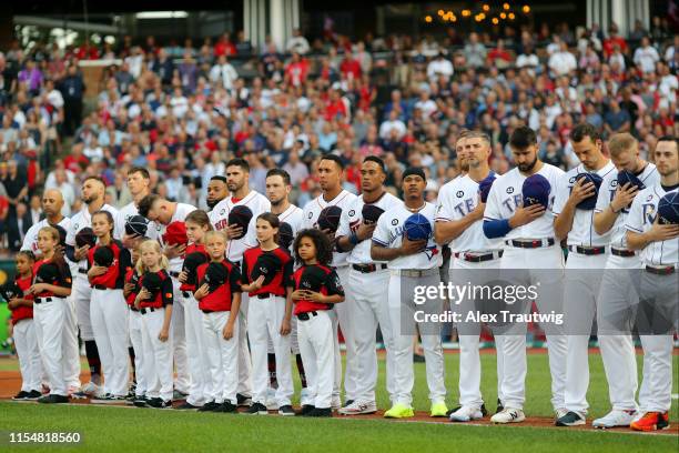 Members of the American League All-Star team are seen on the base path during singing of the national anthem prior to the 90th MLB All-Star Game at...