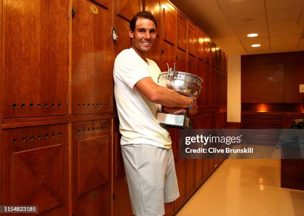 Rafael Nadal of Spain celebrates in the locker room with the winners trophy following the mens singles final against Dominic Thiem of Austria during...