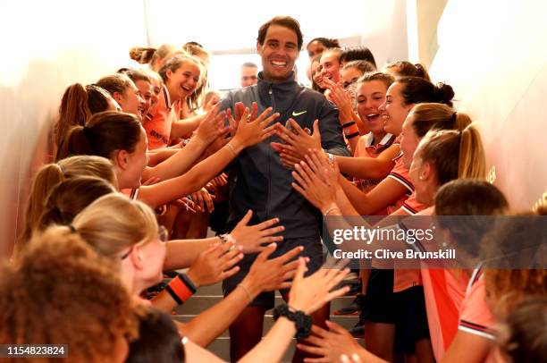 Rafael Nadal of Spain leaves the court as he is congratulated on victory from the ball boys and girls following the mens singles final against...