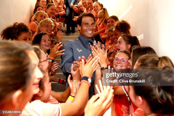 Rafael Nadal of Spain leaves the court as he is congratulated on victory from the ball boys and girls following the mens singles final against...