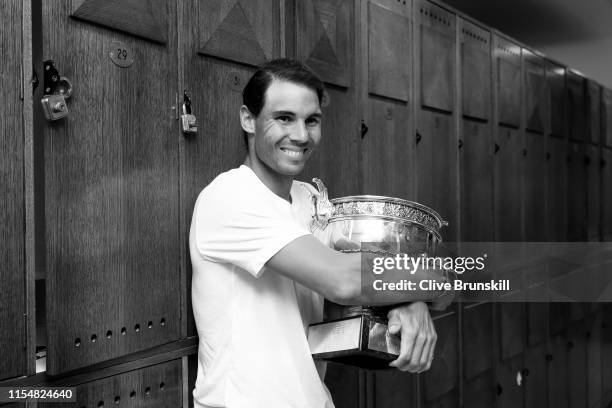 Rafael Nadal of Spain celebrates in the locker room with the winners trophy following the mens singles final against Dominic Thiem of Austria during...