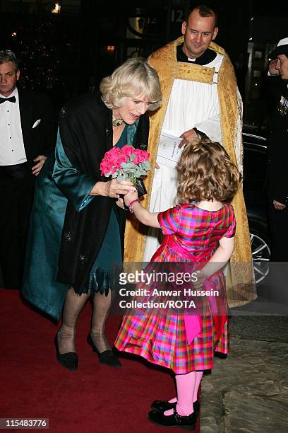 Camilla, Duchess of Cornwall receives a posy of flowers from Emelia Jones, daughter of singer and TV presenter Aled Jones, as she arrives for the...