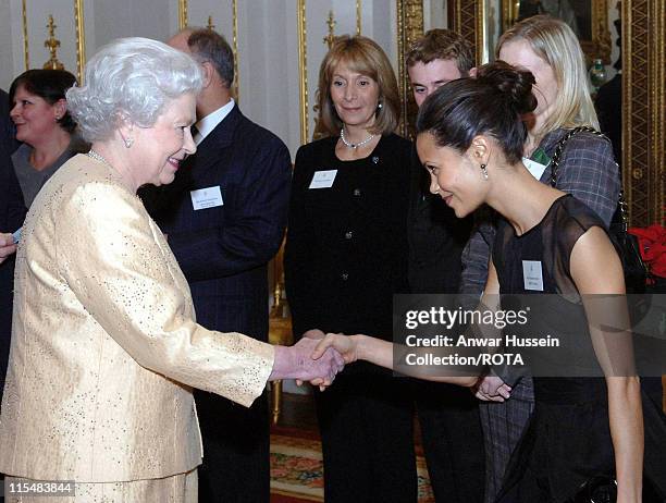 Queen Elizabeth ll meets actress Thandie Newton at a Buckingham Palace reception for the country's top achievers on December19, 2006 in London,...
