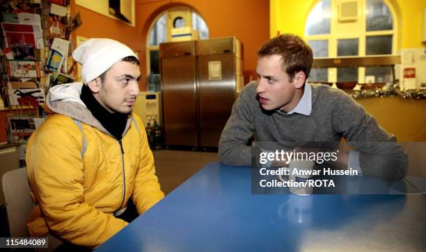 Prince William talks to homeless Ali Lyiguven at a Centrepoint homeless hostel in London during his visit to the centre on December 20, 2006....