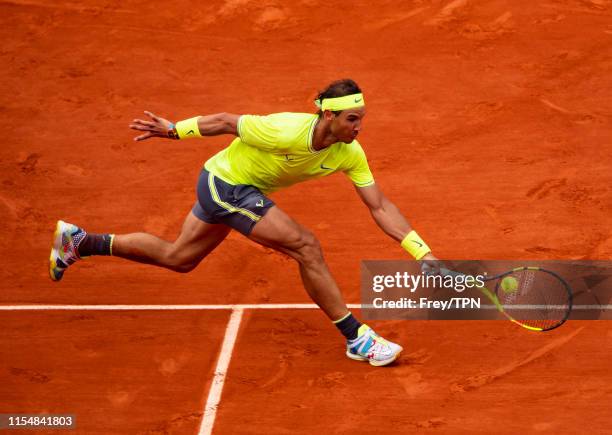 Rafael Nadal hits a forehand against Dominic Thiem of Austria in the final of the men's singles during Day 15 of the 2019 French Open at Roland...