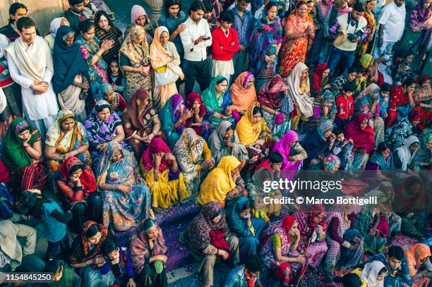 women in colorful dresses sittin in a ghat in vrindavan, india - uttar pradesh assembly stock pictures, royalty-free photos & images