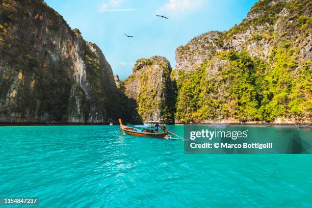 longtail boats in pileh lagoon, phi phi islands, thailand - phi phi islands stock pictures, royalty-free photos & images