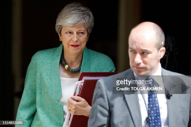 Britain's Prime Minister Theresa May leaves 10 Downing Street in London on July 10 ahead of the weekly Prime Minister's Questions question and answer...