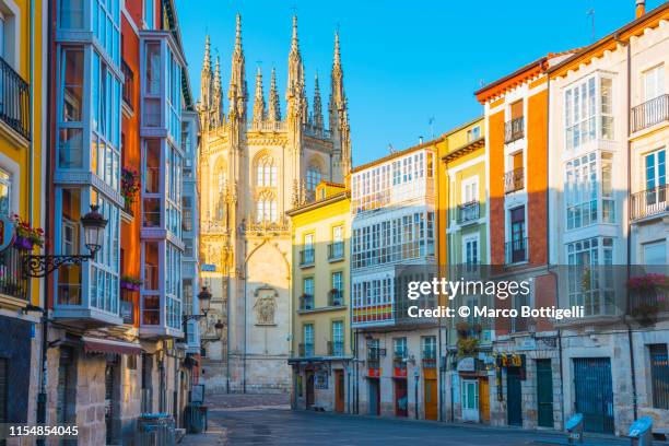 colorful houses and the burgos cathedral, burgos, spain - burgos stock pictures, royalty-free photos & images