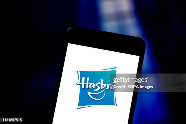 In this photo illustration a Hasbro logo seen displayed on a smartphone.