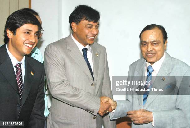 ArcelorMittal Chairman and Chief Executive Officer Lakshmi Mittal shakes hand with Union Minister for Petroleum and Natural Gas Murali Deora as...