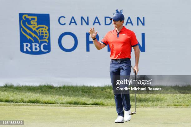 Rory McIlroy of Northern Ireland reacts after a birdie putt on the 14th green during the final round of the RBC Canadian Open at Hamilton Golf and...