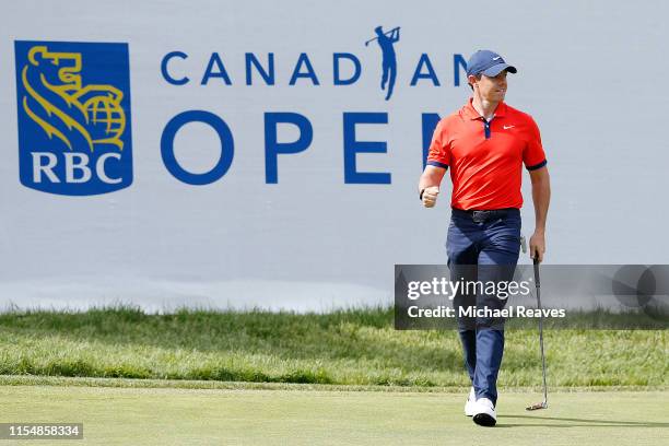 Rory McIlroy of Northern Ireland reacts after a birdie putt on the 14th green during the final round of the RBC Canadian Open at Hamilton Golf and...