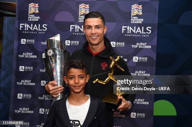 Cristiano Ronaldo of Portugal poses with his son, Cristiano Ronaldo Jr, along with his Top Scorer of the Competition award and the UEFA Nations...