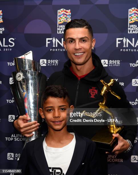 Cristiano Ronaldo of Portugal poses with his son, Cristiano Ronaldo Jr, along with his Top Scorer of the Competition award and the UEFA Nations...