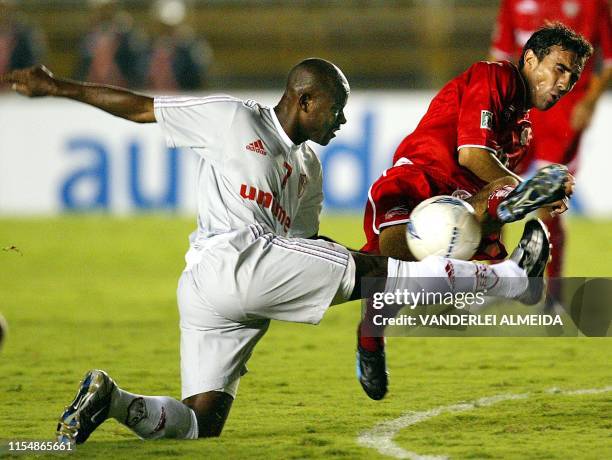 Toluca Mexican team player, Antonio Naelson , kicks the ball against Marcao of the Brazilian team Fluminense, during a friendly match to commemorate...