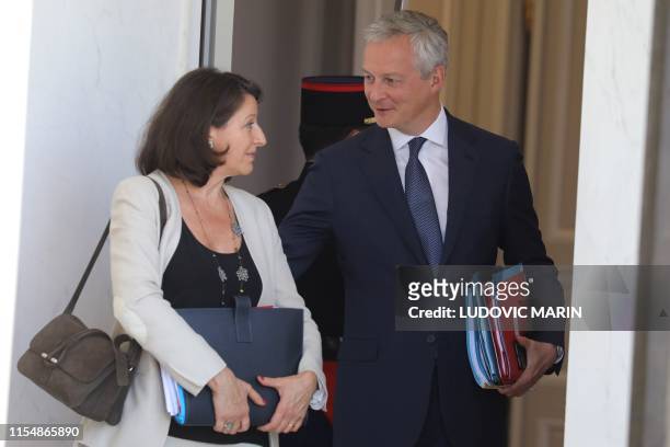 French Health and Solidarity Minister Agnes Buzyn speaks with French Economy and Finance Minister Bruno Le Maire as they leave the weekly cabinet...
