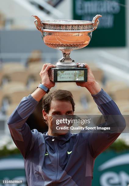 Rafael Nadal of Spain celebrates with the trophy following the mens singles final against Dominic Thiem of Austria during Day fifteen of the 2019...