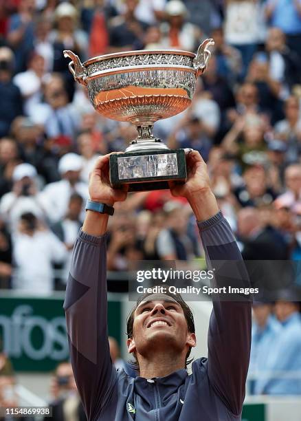 Rafael Nadal of Spain celebrates with the trophy following the mens singles final against Dominic Thiem of Austria during Day fifteen of the 2019...